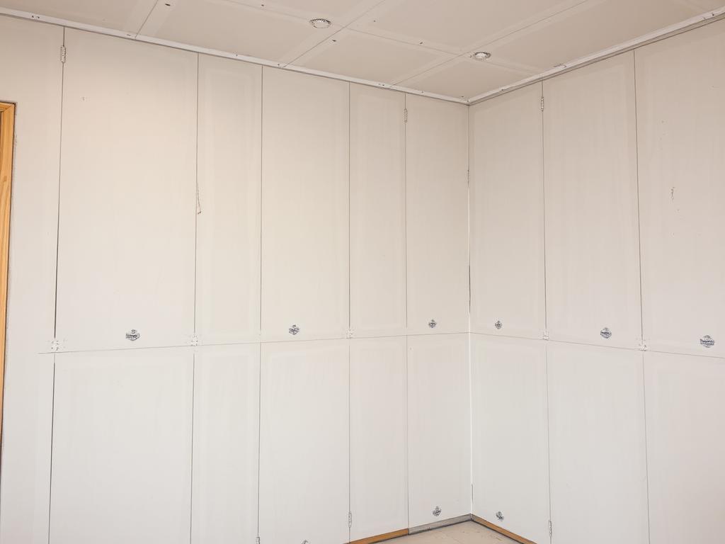 Unfinished drywall with visible seams and screws